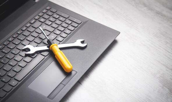 wrench and screwdriver on the computer keyboard it service support free photo
